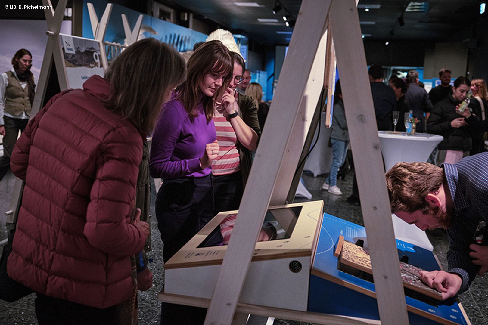 Museumsbesucher an Ausstellungsstation